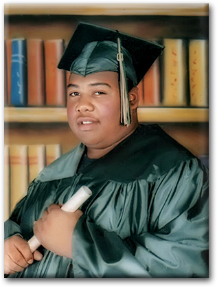 A man in graduation gown holding a white pen.